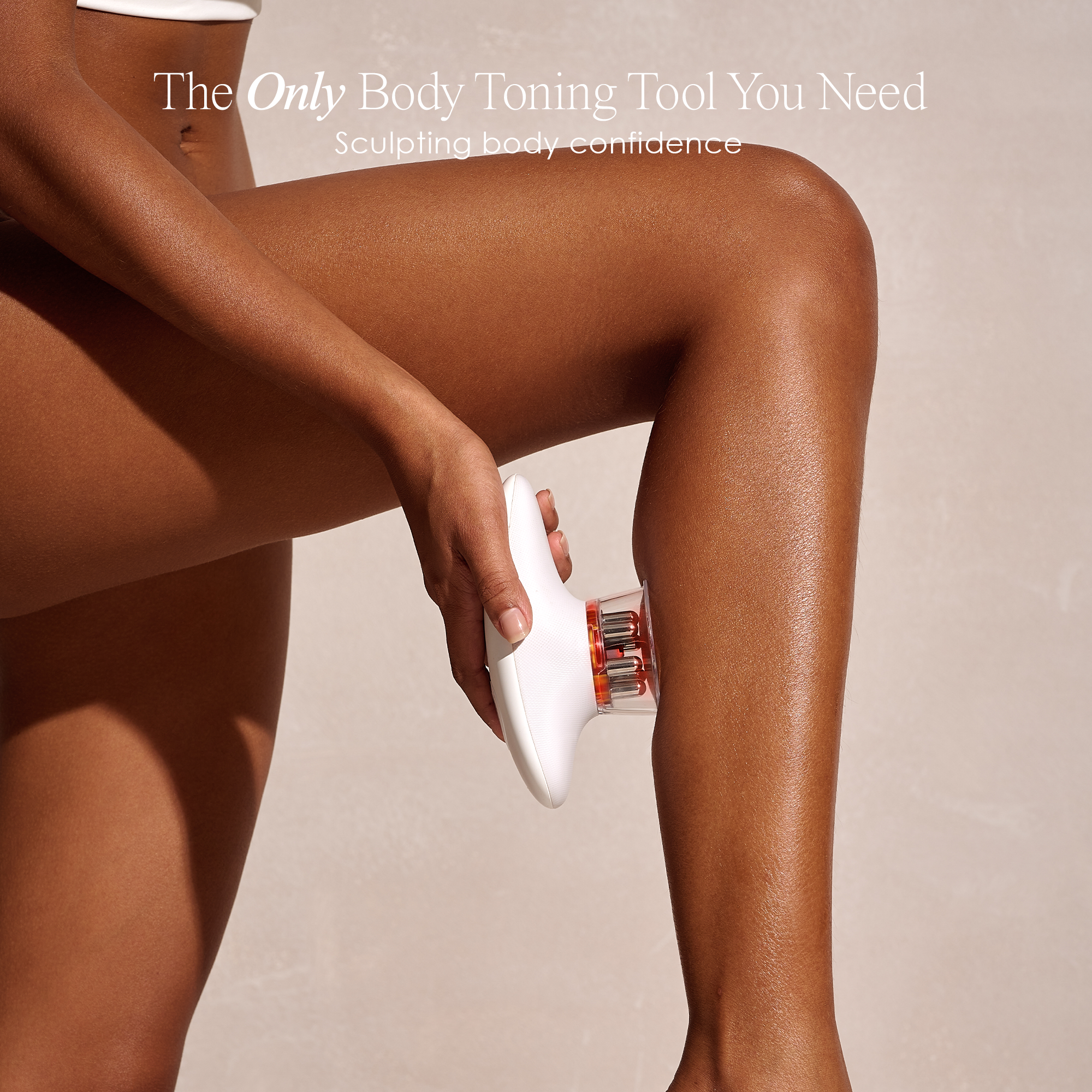 Woman holding SERA device against leg for toning and firming