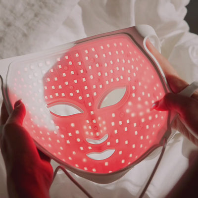 Video: hands holding the LumaLux Face V2 mask to show its illuminated inner LED array